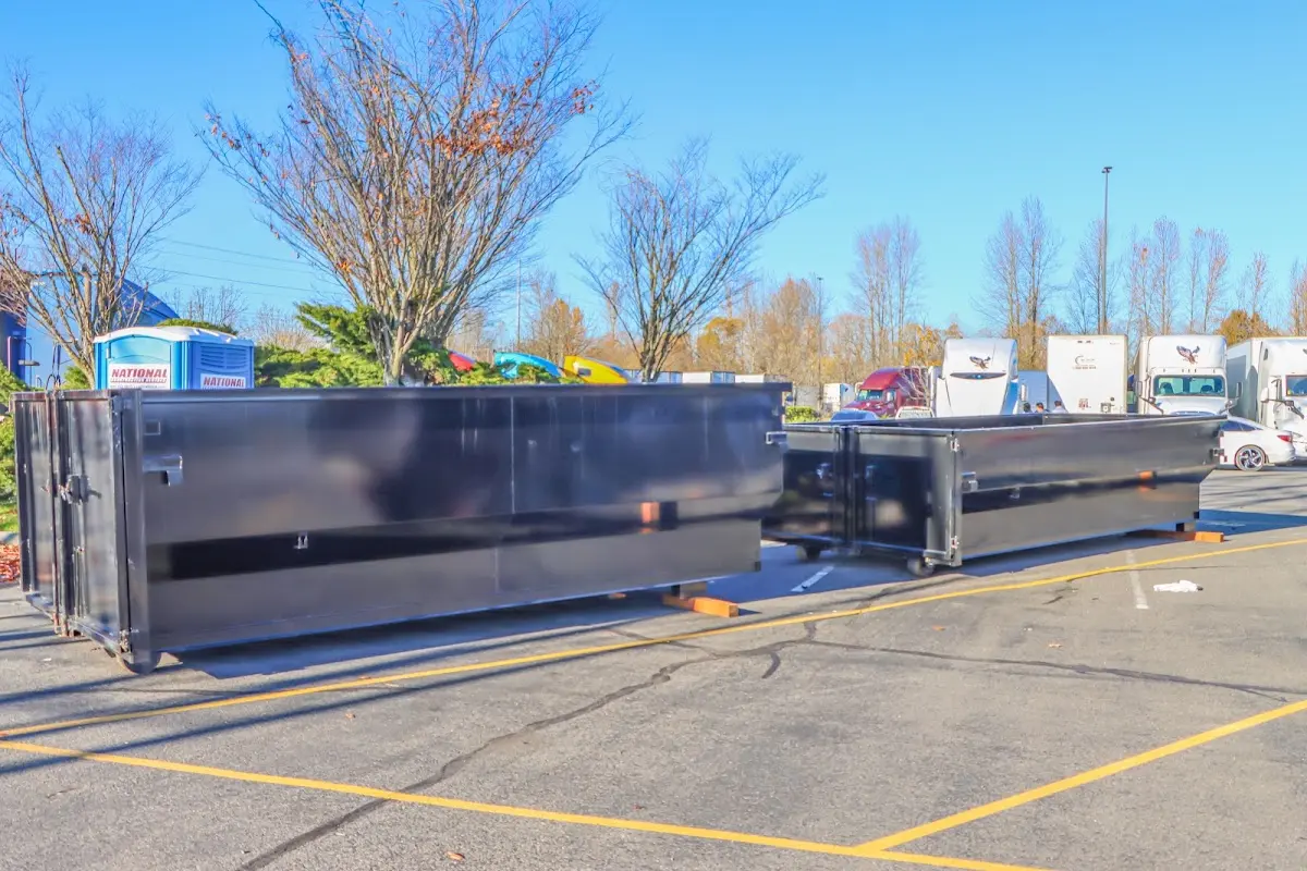 Professional dumpster rental service with roll-off container on residential driveway in Bridgeview